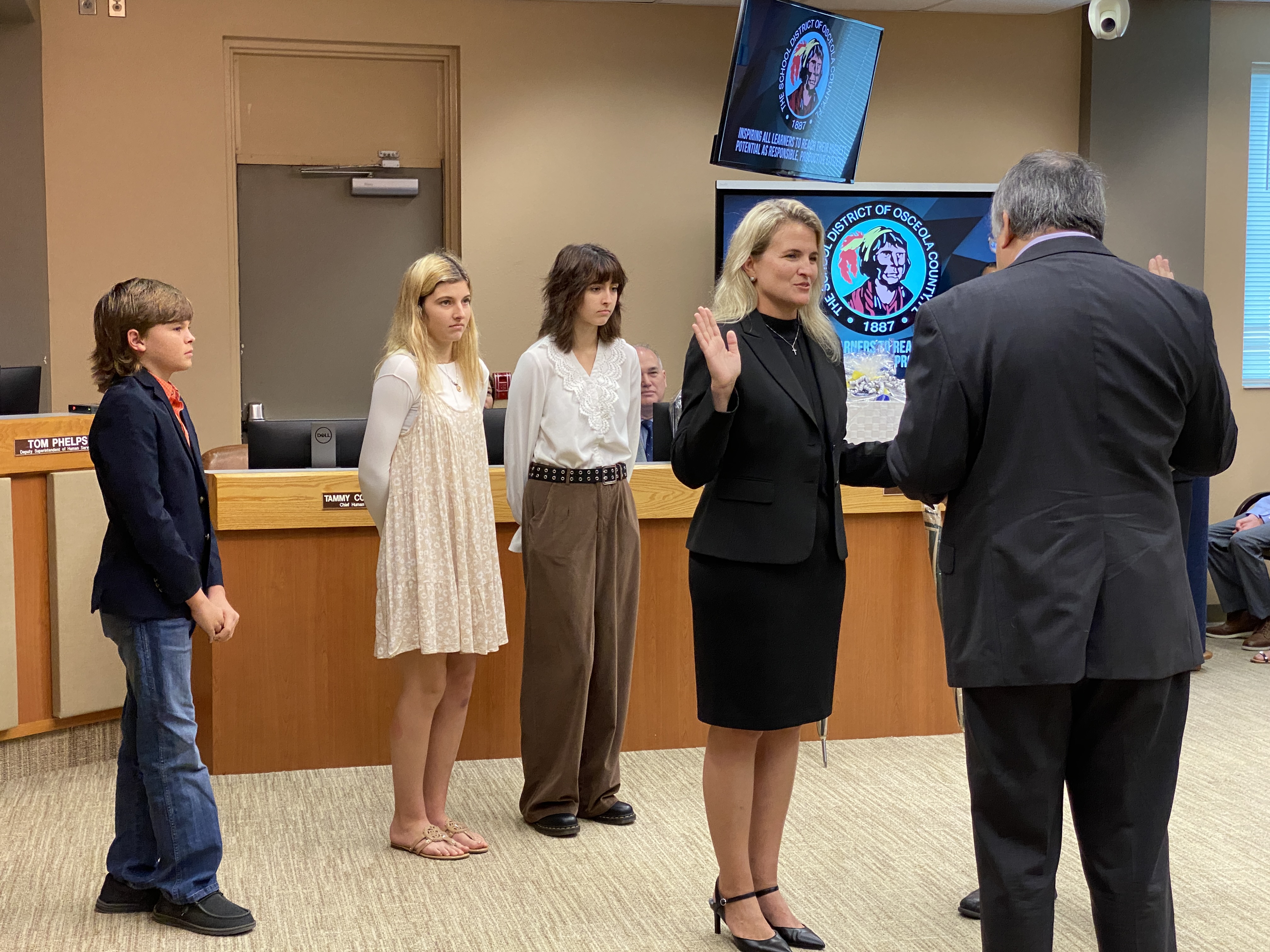 Mrs. Booth’s three children looking on as she is sworn into the school board.